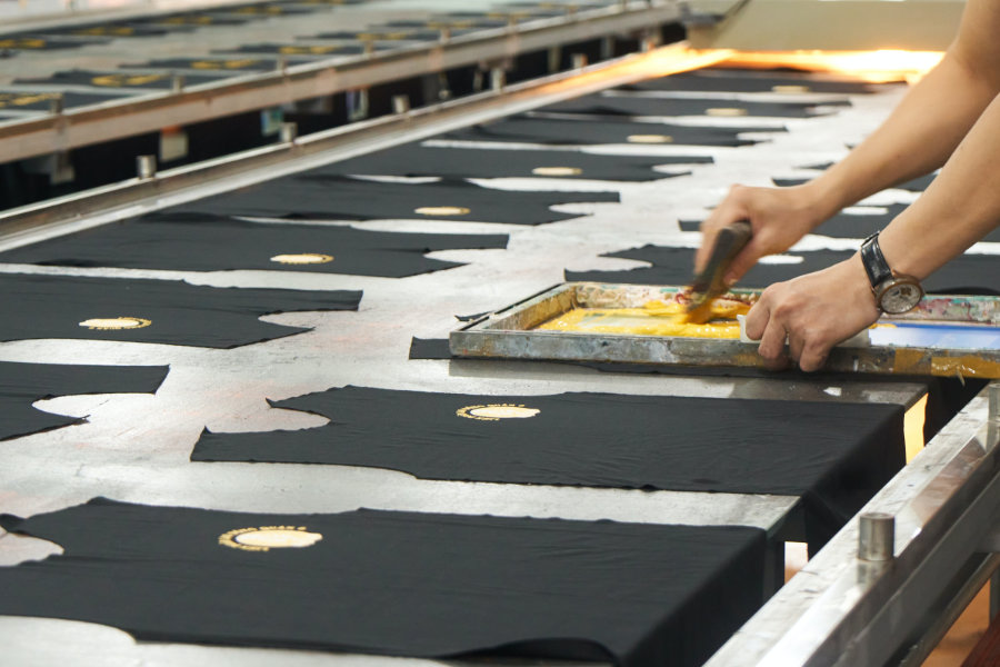 A person screen printing tshirts