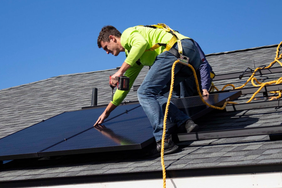 Solar panel being installed on a roof