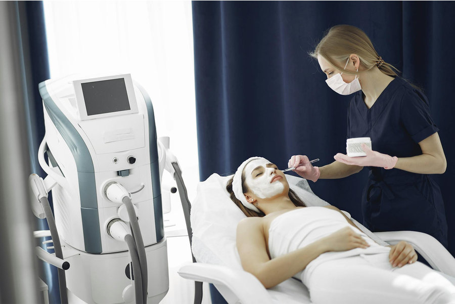 Woman receiving a facial treatment in a medical setting
