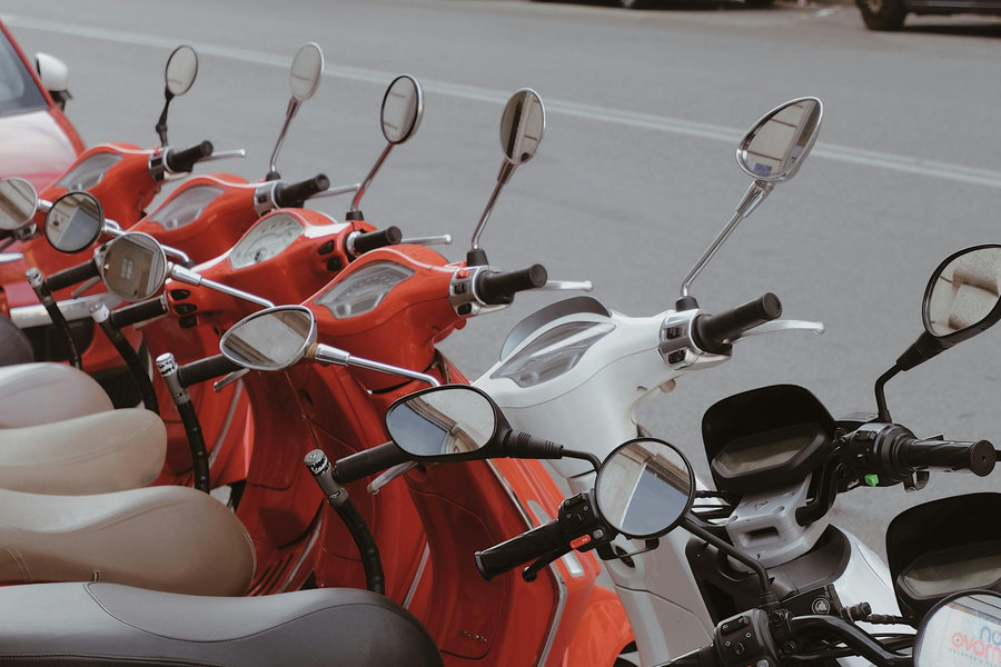 Scooters lined up at a scooter hire business