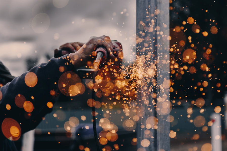 Sparks flying from an angle grinder on steal